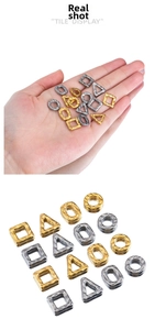 Detail of hammered metal geometric pendants in square, circle and triangle shapes
