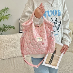 Pink quilted canvas bag with rabbit floral print and adjustable shoulder strap