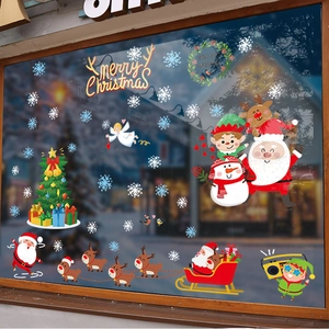 Christmas window decals with Santa, reindeer and snowflakes on a glass shop storefront