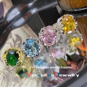 Detailed macro view of four luxury oval-cut gemstone rings with ornate pavé settings