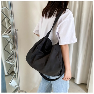 Model view showing the large black oxford crossbody bag with adjustable shoulder strap