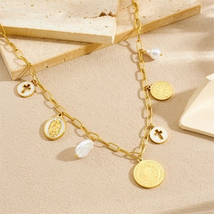 Golden layered necklace featuring baroque pearls, white shell crosses, and religious medals