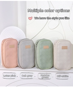 Detail of woven texture pencil bags in pink, gray, green and beige with leather patch