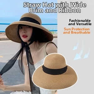 Detail of wide brim straw sun hat featuring a classic black silk ribbon tie