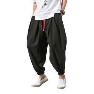 Men's loose harem pants in black featuring a contrasting red drawstring on white background