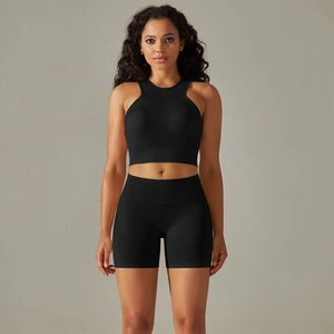 Detail of seamless black sports bra and high-waisted shorts set for yoga and fitness