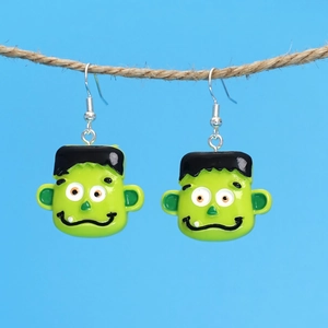 Vibrant green Frankenstein Halloween drop earrings displayed on a rustic hemp rope