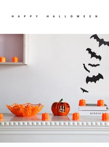 Halloween decor set with orange pumpkin lantern, spider web bowl, and bat wall stickers