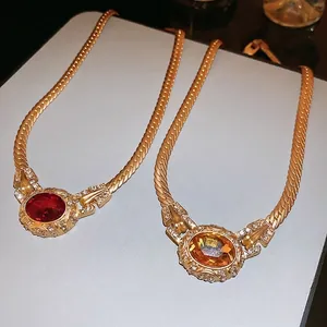 Vintage gold necklaces with oval red and amber stones on wide snake chains