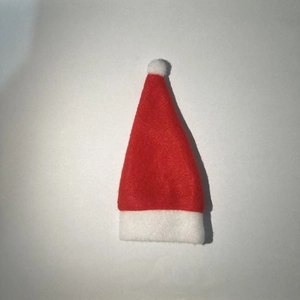 Close-up of mini red and white felt Christmas hat used for doll or bottle decor
