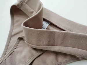Close-up of ribbed cotton panties showing elastic waistband and detailed size tag