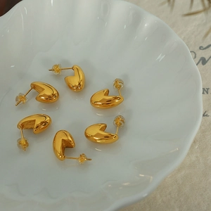 Minimalist 18K gold plated bean stud earrings set displayed on a white shell plate
