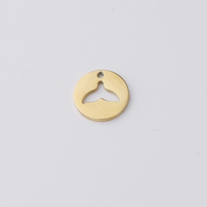 Detailed view of a gold circular pendant with a hollow mermaid tail DIY jewelry part