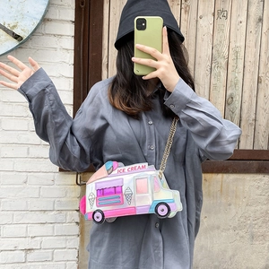Detail of colorful laser ice cream truck crossbody bag with gold chain strap on model