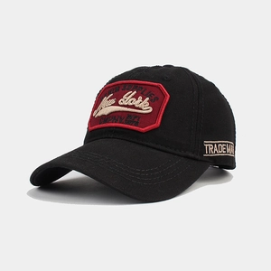 Close-up of red New York embroidery on black cotton baseball cap with trademark detail