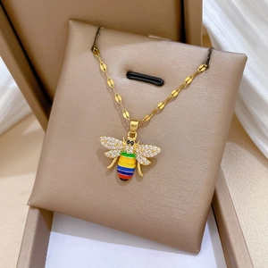 Golden bee necklace with rainbow enamel wings and sparkling crystals in a gift box