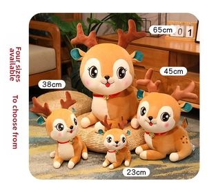 Detail of four brown plush reindeer toys in different sizes with bells and ribbons