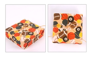 Detail of sports-themed kraft gift wrap with ball patterns and natural jute twine ties