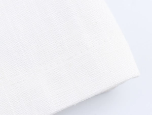 Close-up of white linen fabric texture showing high-quality weaving and stitching