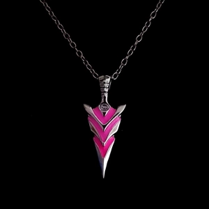 Close-up of arrow pendant necklace with glowing pink resin inlays on black background