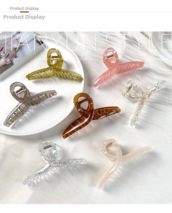 Macro shot of 7-color jelly large PC hair claws on a tray with JIANYUN STYLE branding