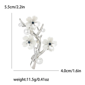 Detail view of flower brooch showing three white blossoms and pearls with dimensions