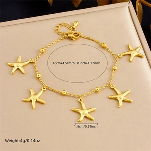 Detail of golden stainless steel starfish charm bracelet on a satin jewelry display