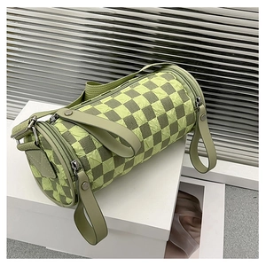 Detail of checkered cylinder bag with pleated texture and adjustable wide shoulder strap