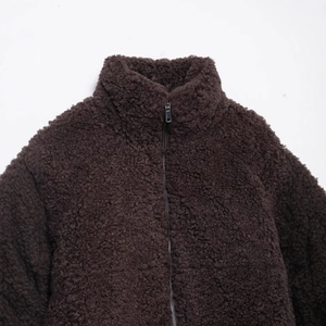 Thick dark brown fleece jacket with high neck zipper and curly sherpa texture