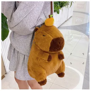 Detail of soft capybara plush backpack with a cute yellow orange hair accessory