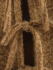 Macro view of a decorative brown plush bow knot showing high-quality fuzzy texture