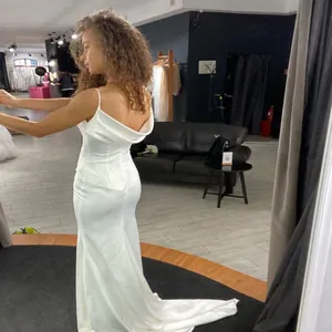 Elegant minimalist white satin mermaid wedding dress with spaghetti straps and open back