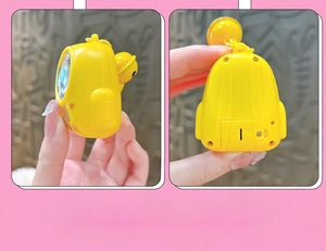 Detail showing the back battery compartment and screw fixings of the yellow animal keychain