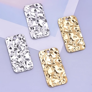 Detailed view of rectangle hammered wave texture pendants in gold and silver finish