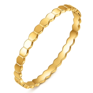 Minimalist gold hexagonal honeycomb bangle with a polished finish and hidden clasp