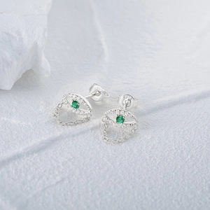 Close-up of S925 silver eye earrings with green stone and delicate chain fringe