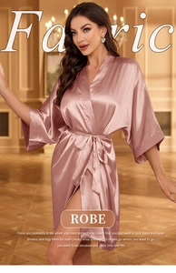 Detail of rose pink satin silk robe showing waist tie and elegant smooth fabric texture
