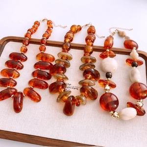 Maillard style acrylic amber beaded necklace with irregular oval beads and golden clasp