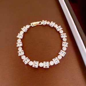 Detail of 18k gold plated bracelet with alternating rectangular and round crystals