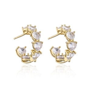 Detail of gold C-shaped hoop earrings with heart-cut crystals in a claw setting