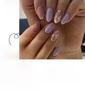 Detail of short almond press-on nails featuring purple floral designs and gold glitter edges