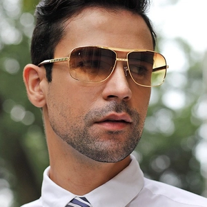 Retro square metal sunglasses with gold frames and brown gradient lenses on a male model