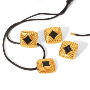 Elegant gold square jewelry set with black rhombus stone and textured finish