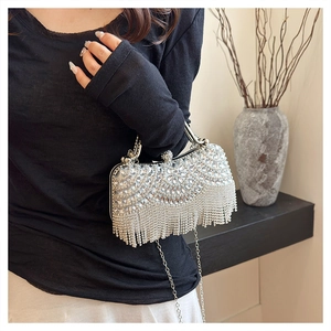 Silver rhinestone fringe clutch bag with chain strap and sparkling tassel detail