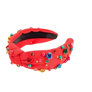 Red wide knot headband with colorful crystal flowers and pearls on white background