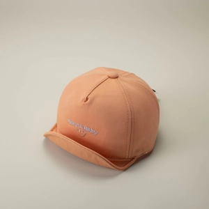 Detail of orange cotton baby baseball cap with Bonita embroidery and soft peak design