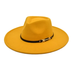 Close-up of ginger yellow wide-brim fedora with black leather band and gold buckle detail