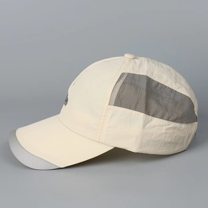 Detail of breathable grey mesh fabric and quick-dry material on beige baseball cap