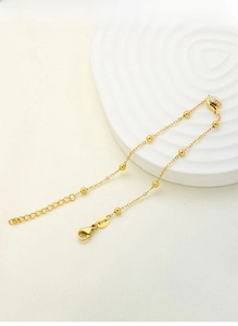 Macro shot of 18K gold plated titanium steel necklace with zircon flower pendant