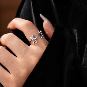 Vintage hollow flower open ring in polished silver finish worn on model finger
